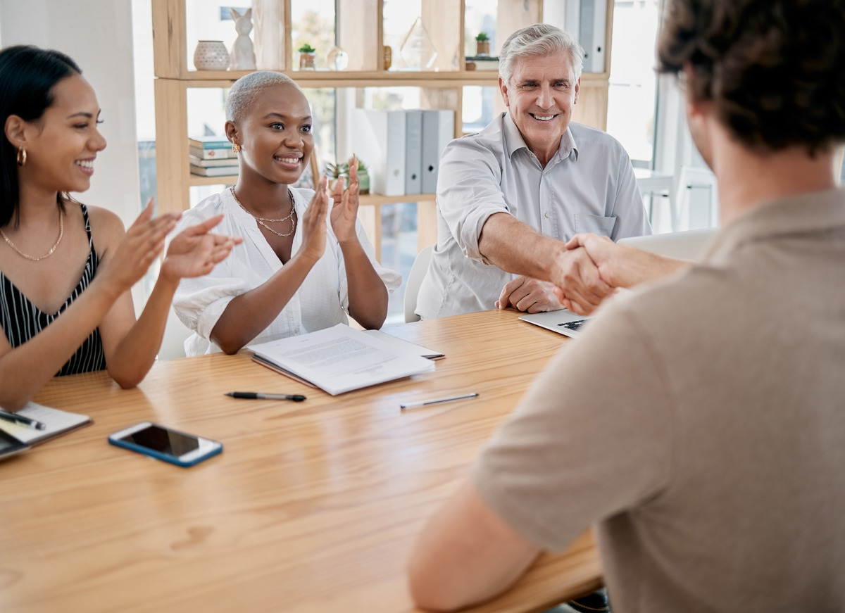 HR professionals celebrating a successful agreement with a handshake