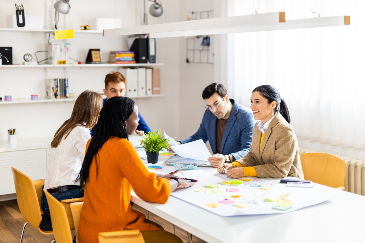 A diverse startup team gathered in a modern office