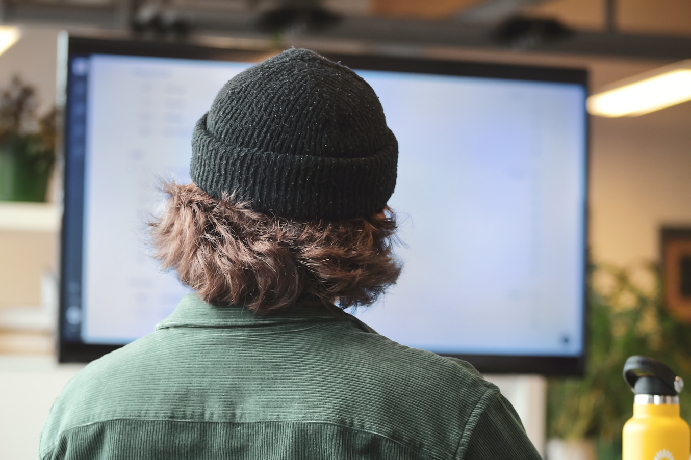 A learner studying cybersecurity content at a large screen