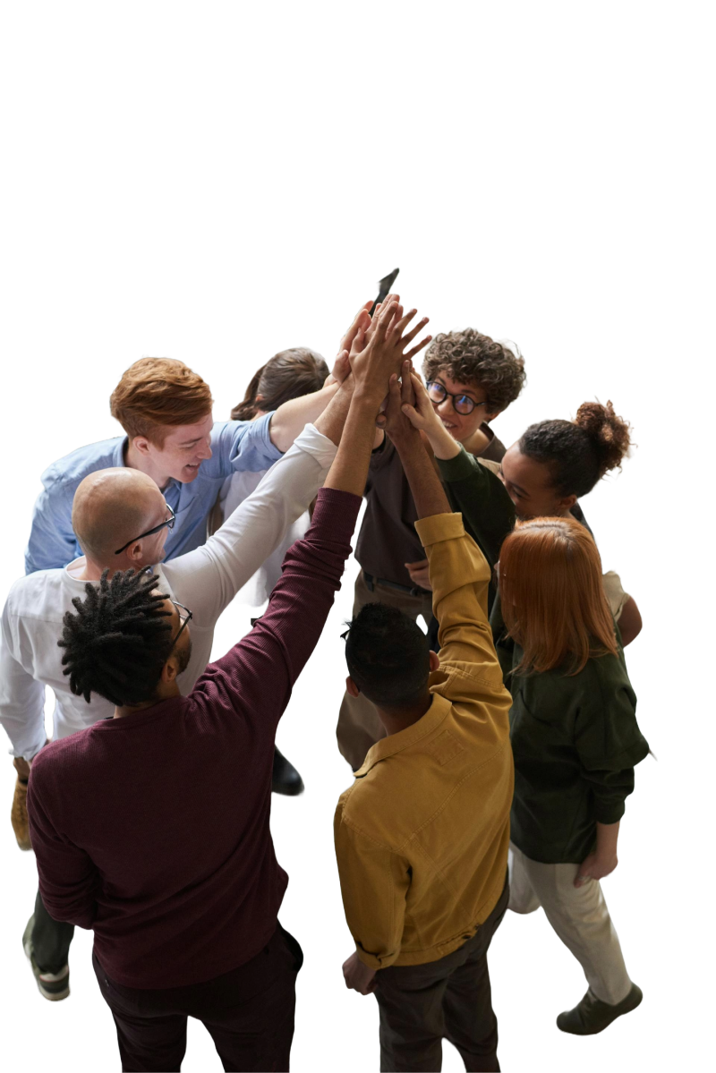 Group of people in a circle holding their hands together in the air.